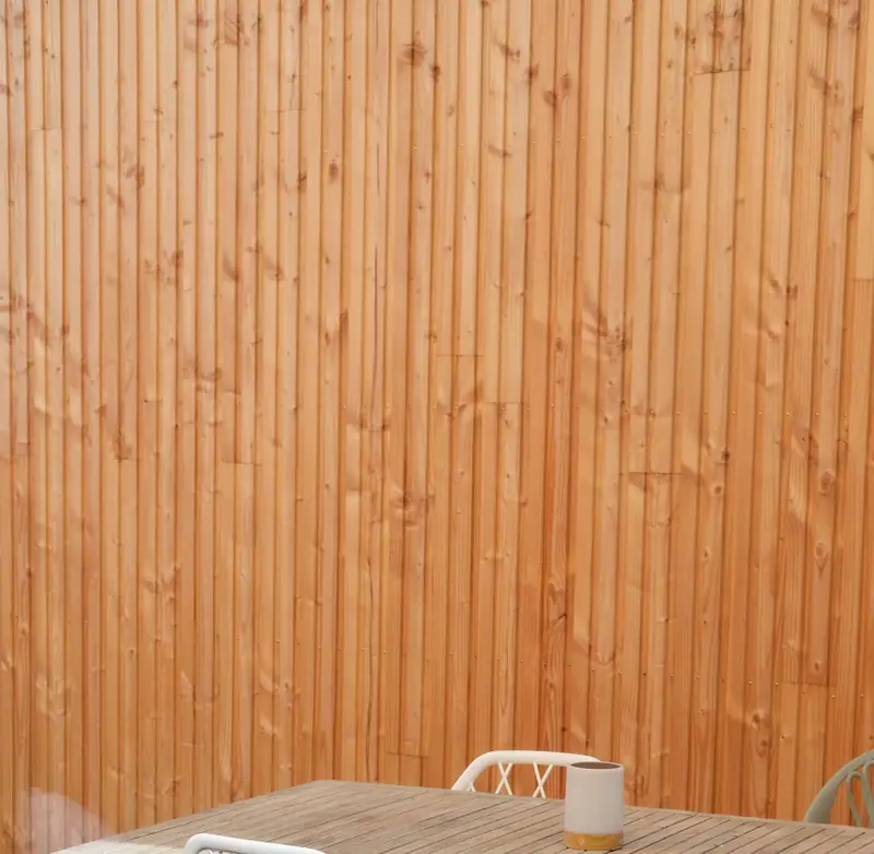 Close view of a new vertical-board cedar privacy fence